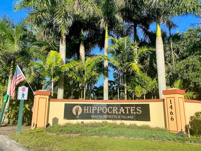 Photo of the entrance to Hippocrates, with a large sign reading "Hippocrates - Health Institute & Village"